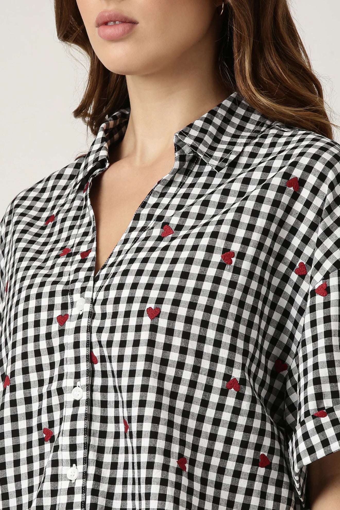 GINGHAM HEART EMBROIDERED SHIRT Classic checks? They just got a stylish upgrade. This shirt is all about fresh vibes and fun, made for the modern woman who knows how to make a statement.